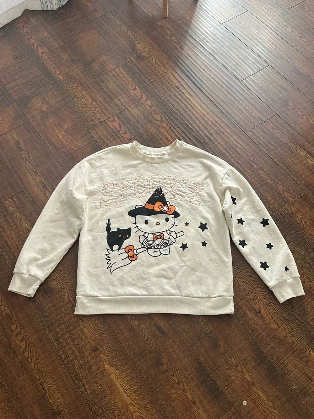 Hello Kitty Cream Crewneck Sweater with Black Star Accents